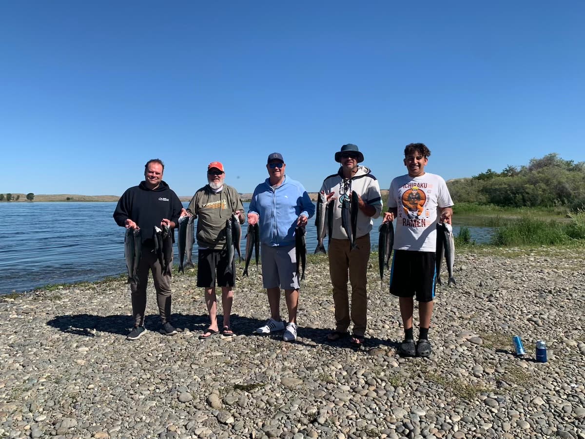 Group of five anglers with salmon catch along Columbia River in central Washington
