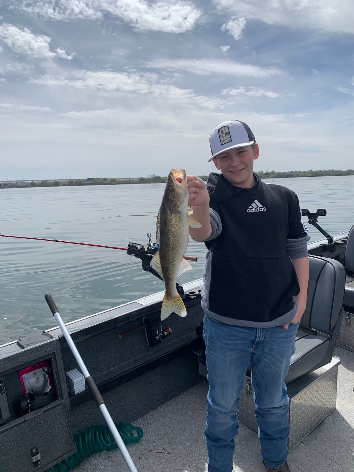 Young boy holding walleye on guided fishing boat on the Columbia River