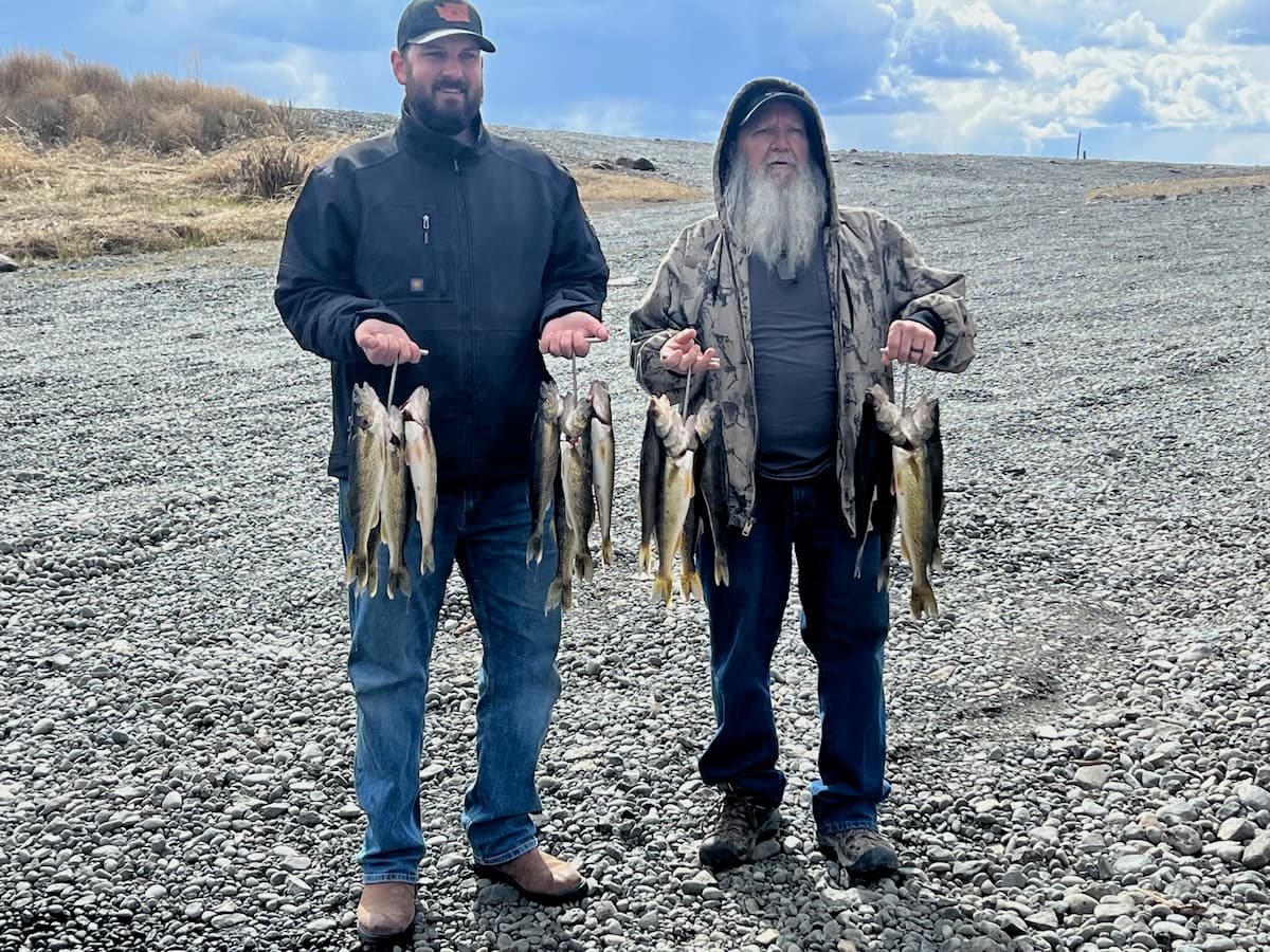 Two anglers holding their fish haul on guided trip in Washington